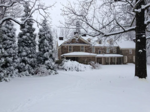 The back of the mansion on a snowy day.